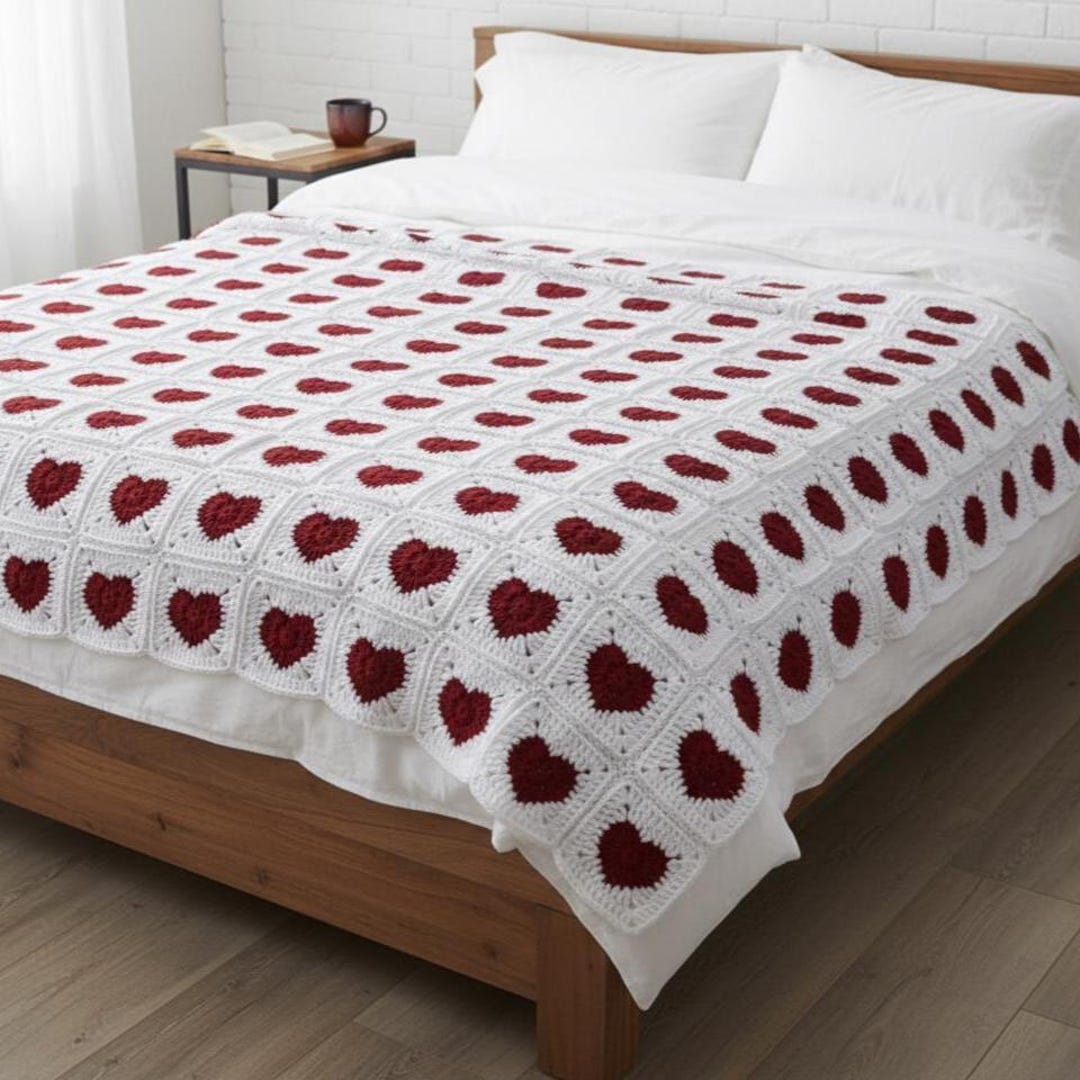 White crochet granny squares with red heart centers on a wooden table, PDF pattern with video tutorial